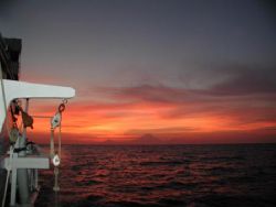 Komodo Sunset over Volcano with smoooth Sailing. by Dale Treadway 